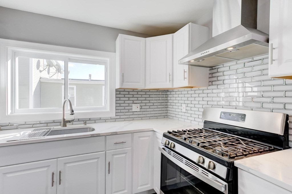51 Prospect Street Woburn, MA 01801 - Photo 1 of 40 a kitchen with granite countertop a stove sink and cabinets