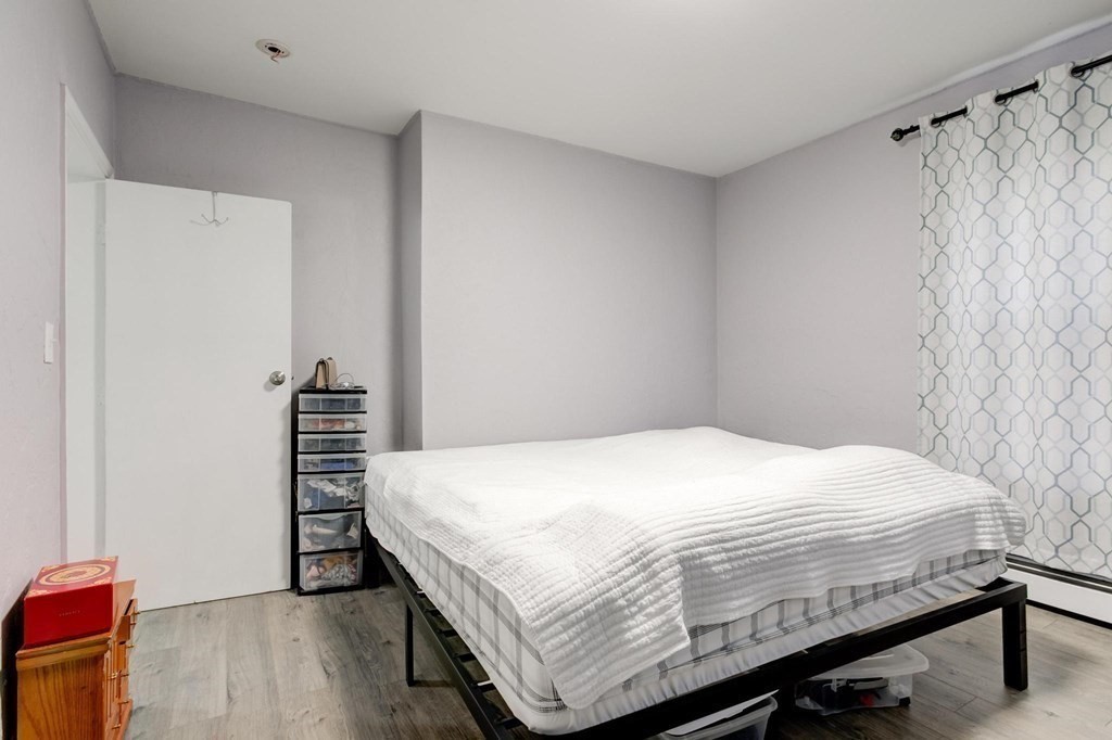 51 Prospect Street Woburn, MA 01801 - Photo 14 of 40 a bedroom with a bed and a dresser