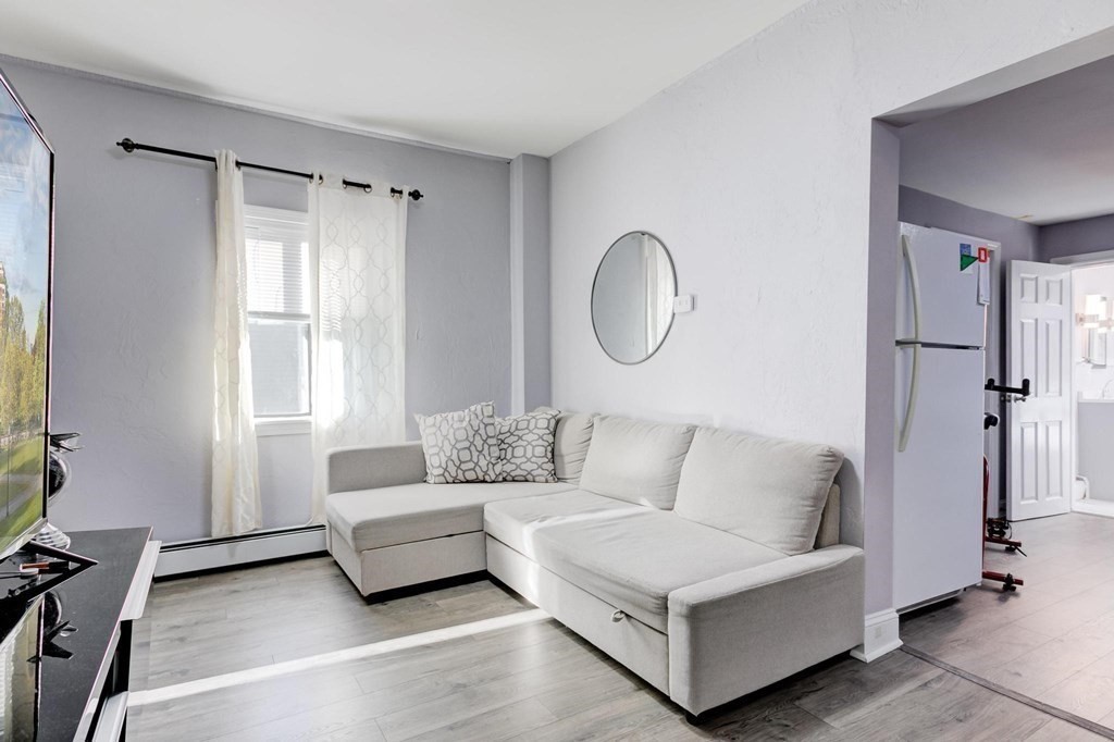51 Prospect Street Woburn, MA 01801 - Photo 16 of 40 a living room with furniture and a window