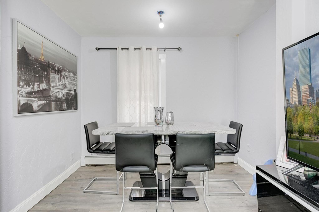 51 Prospect Street Woburn, MA 01801 - Photo 22 of 40 a view of a dining room with furniture and a window