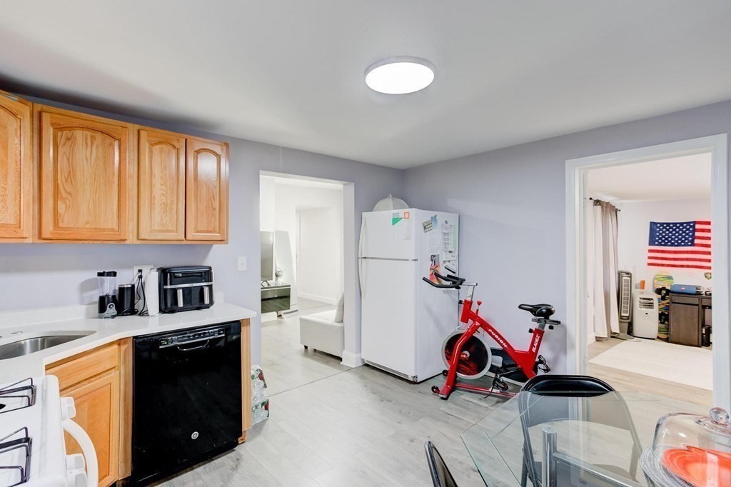 51 Prospect Street Woburn, MA 01801 - Photo 26 of 40 a view of a kitchen with fridge and workspace