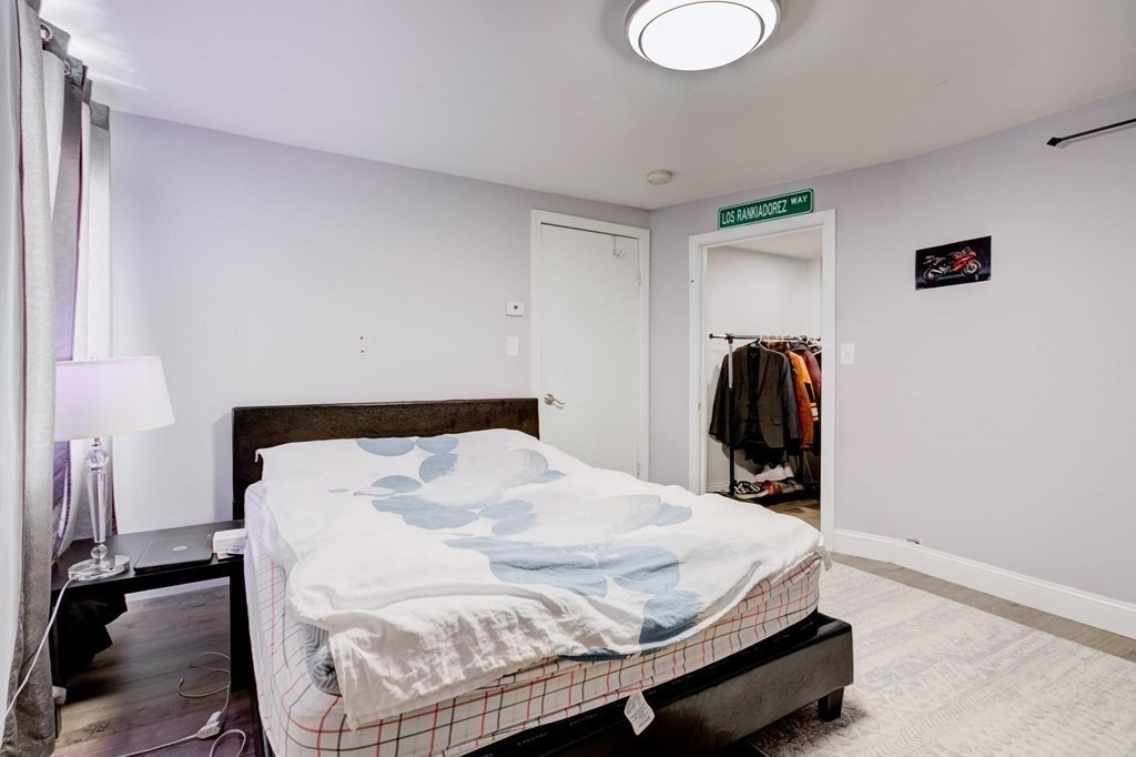 51 Prospect Street Woburn, MA 01801 - Photo 27 of 40 a bed sitting in a bedroom and table