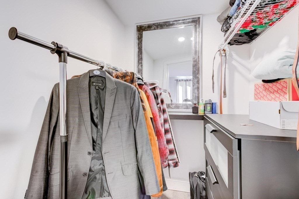 51 Prospect Street Woburn, MA 01801 - Photo 28 of 40 a view of walk in closet with clothes and shoes
