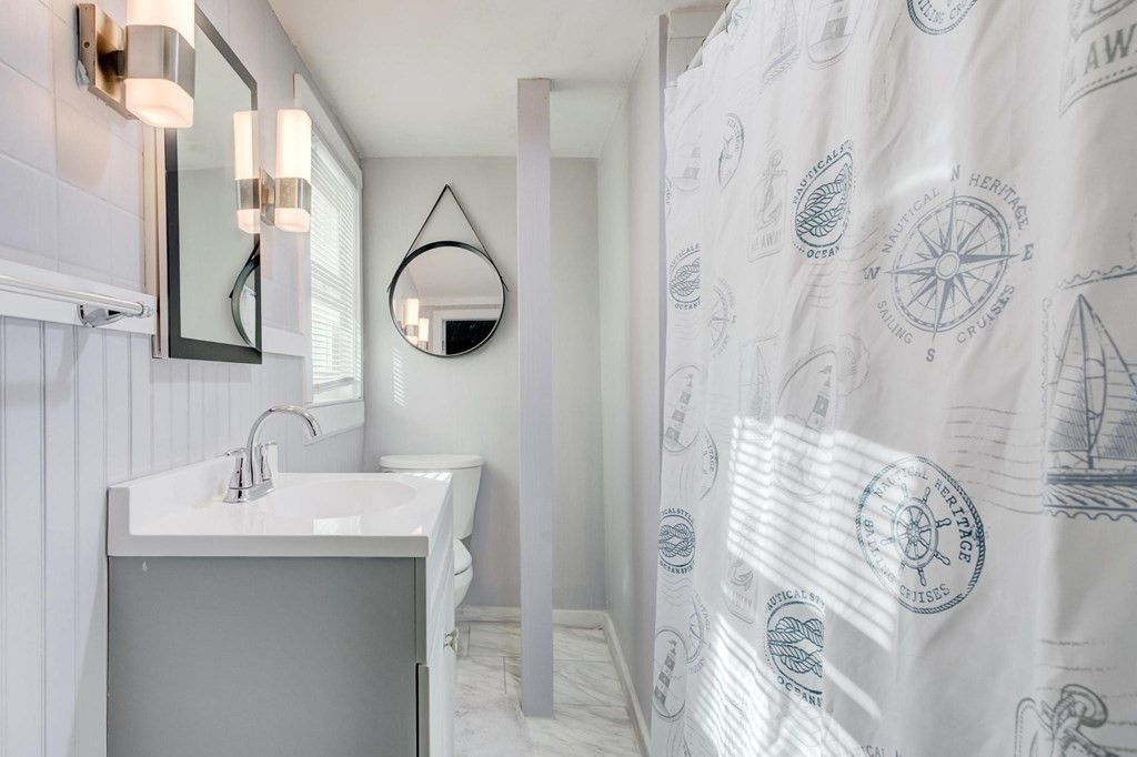 51 Prospect Street Woburn, MA 01801 - Photo 29 of 40 a bathroom with a sink and a mirror