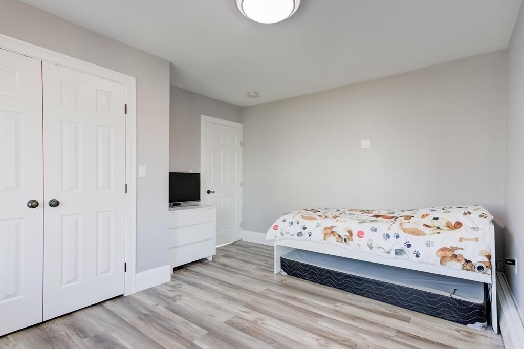 51 Prospect Street Woburn, MA 01801 - Photo 31 of 40 a bedroom with a bed and a window