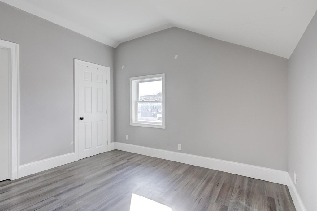51 Prospect Street Woburn, MA 01801 - Photo 32 of 40 an empty room with wooden floor and windows