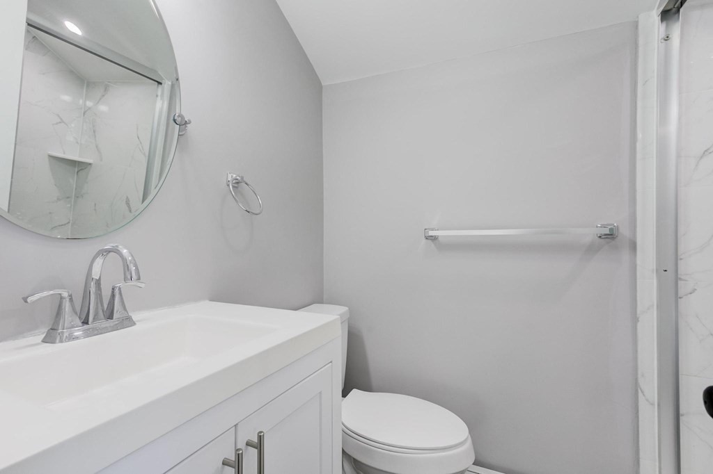 51 Prospect Street Woburn, MA 01801 - Photo 33 of 40 a bathroom with a sink toilet and mirror