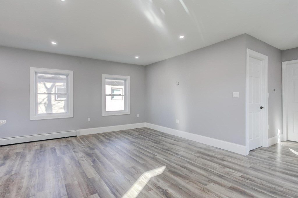 51 Prospect Street Woburn, MA 01801 - Photo 37 of 40 wooden floor in an empty room with a window