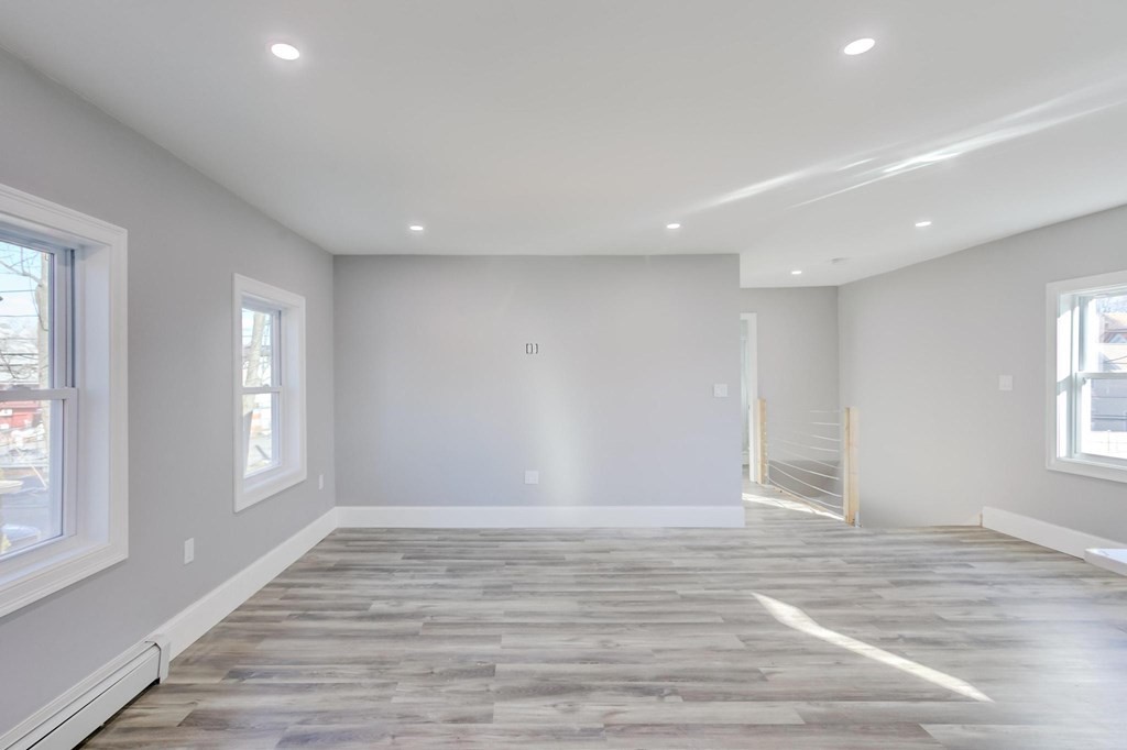51 Prospect Street Woburn, MA 01801 - Photo 39 of 40 wooden floor in an empty room with a window