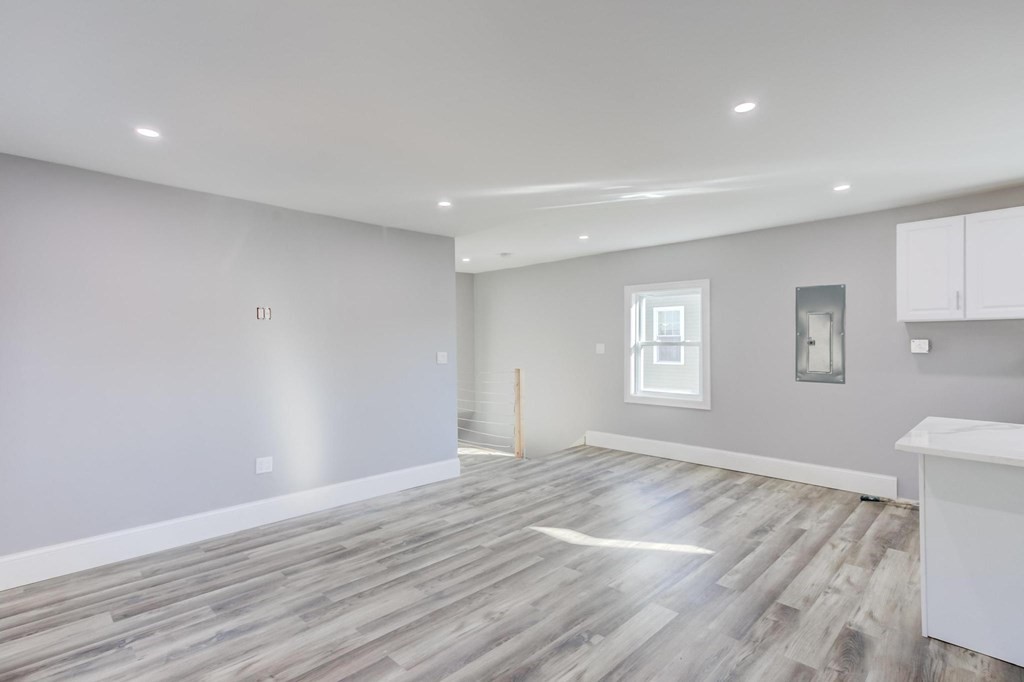 51 Prospect Street Woburn, MA 01801 - Photo 40 of 40 a view of empty room with wooden floor and fan