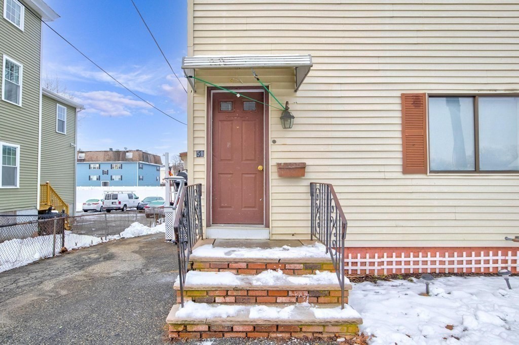 51 Prospect Street Woburn, MA 01801 - Photo 5 of 40 a front view of a house with a outdoor seating