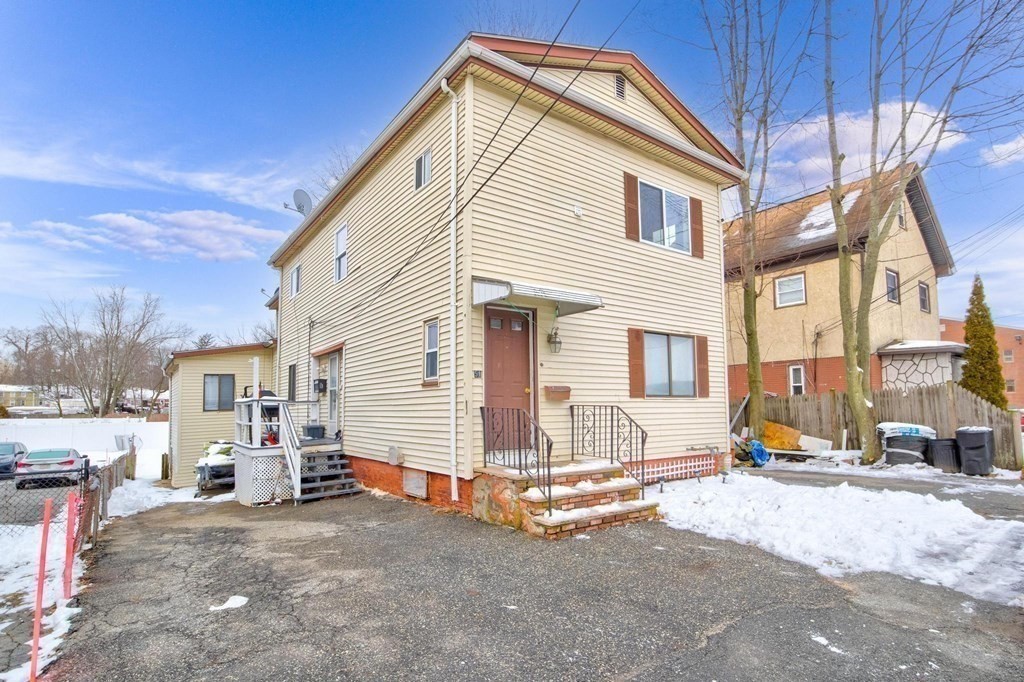 51 Prospect Street Woburn, MA 01801 - Photo 6 of 40 a view of a house with a snow in the background