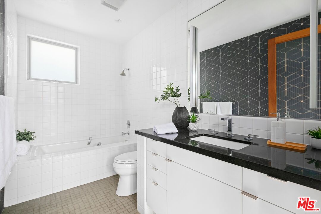 216 Grand Boulevard Venice, CA 90291 - Photo 18 of 30 a bathroom with a granite countertop sink a toilet and shower