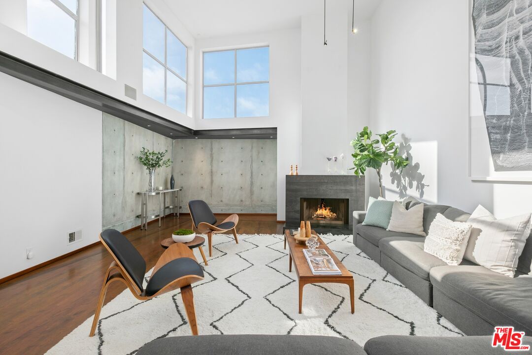 216 Grand Boulevard Venice, CA 90291 - Photo 3 of 30 a living room with furniture a fireplace and a window