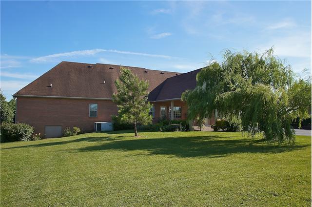 226 Lawrence Lane Springfield, TN 37172 - Photo 19 of 20 The Back of the Home offers Covered Patio/Carport and 1 Car Garage, lots of beautiful flowers.