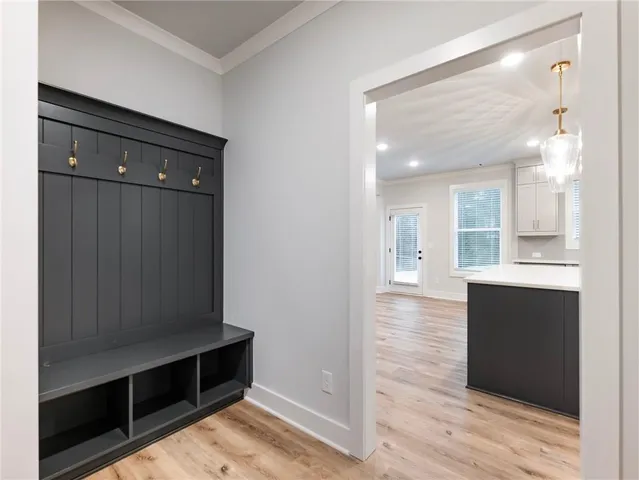 a view of a hallway with wooden floor and closet