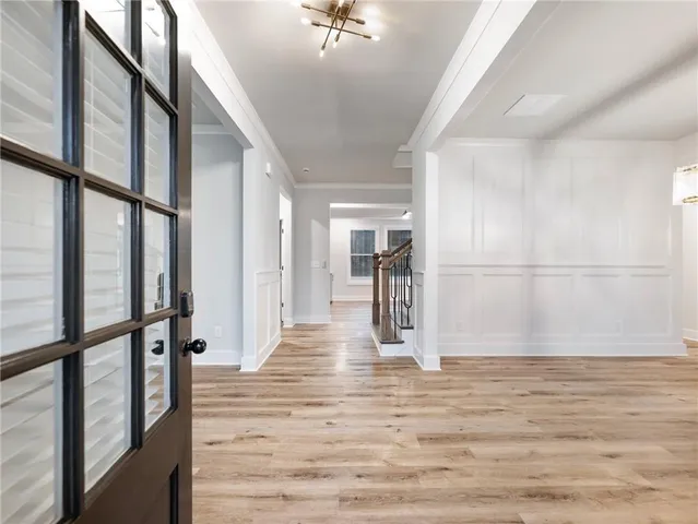 a view of entryway with wooden floor and a chandelier