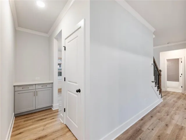 a view of a hallway with wooden floor and entryway