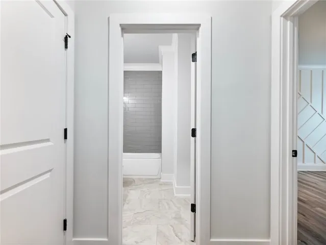 a view of entryway and hall with wooden floor