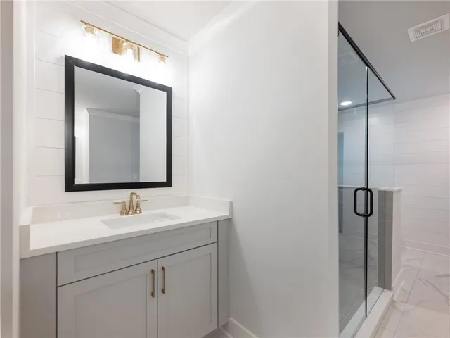 a bathroom with a shower and a mirror