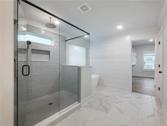 a view of an empty room with wooden floor and staircase