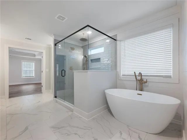 a view of an empty room with wooden floor and stairs