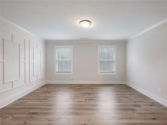 a view of an empty room with wooden floor