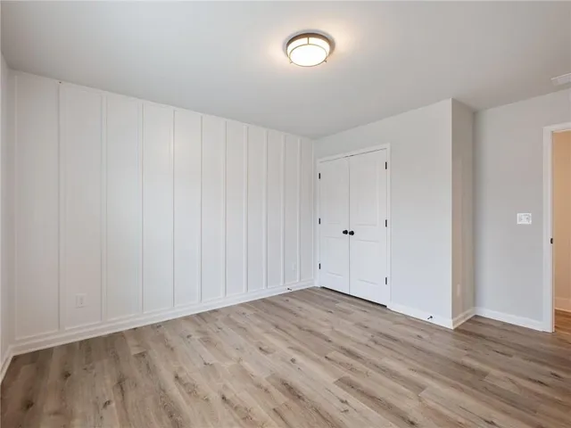 a view of a room with wooden floor and a toilet