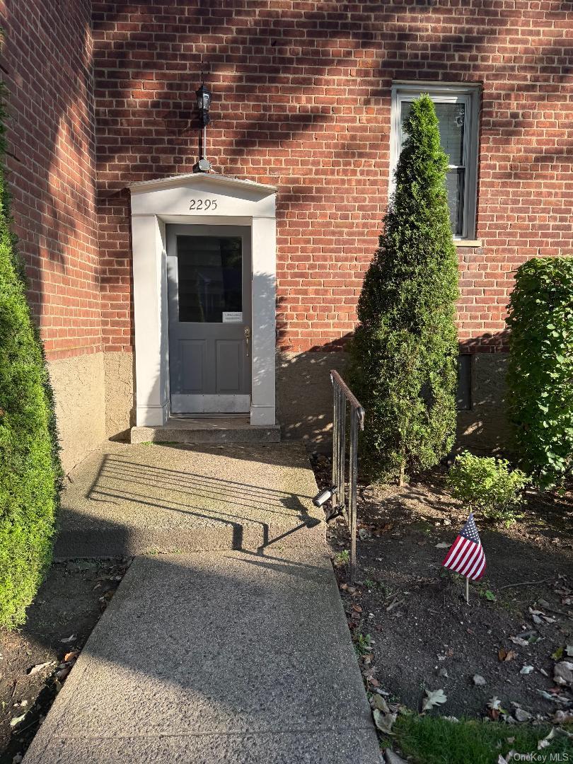 2295 Palmer Avenue, Unit 1N New Rochelle, NY 10801 - Photo 11 of 16 a front view of a house with a yard