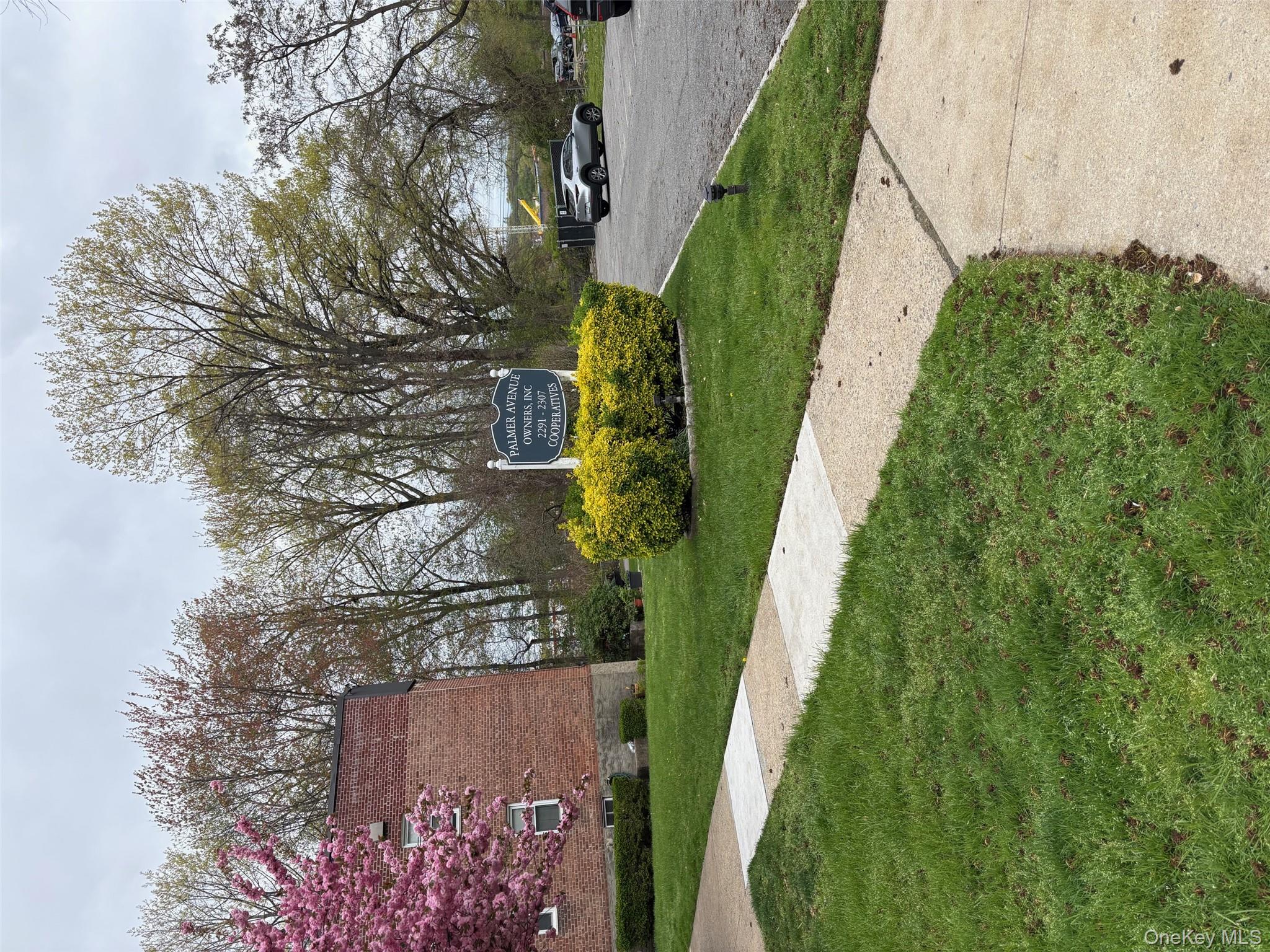 2295 Palmer Avenue, Unit 1N New Rochelle, NY 10801 - Photo 13 of 16 a front view of a house with garden