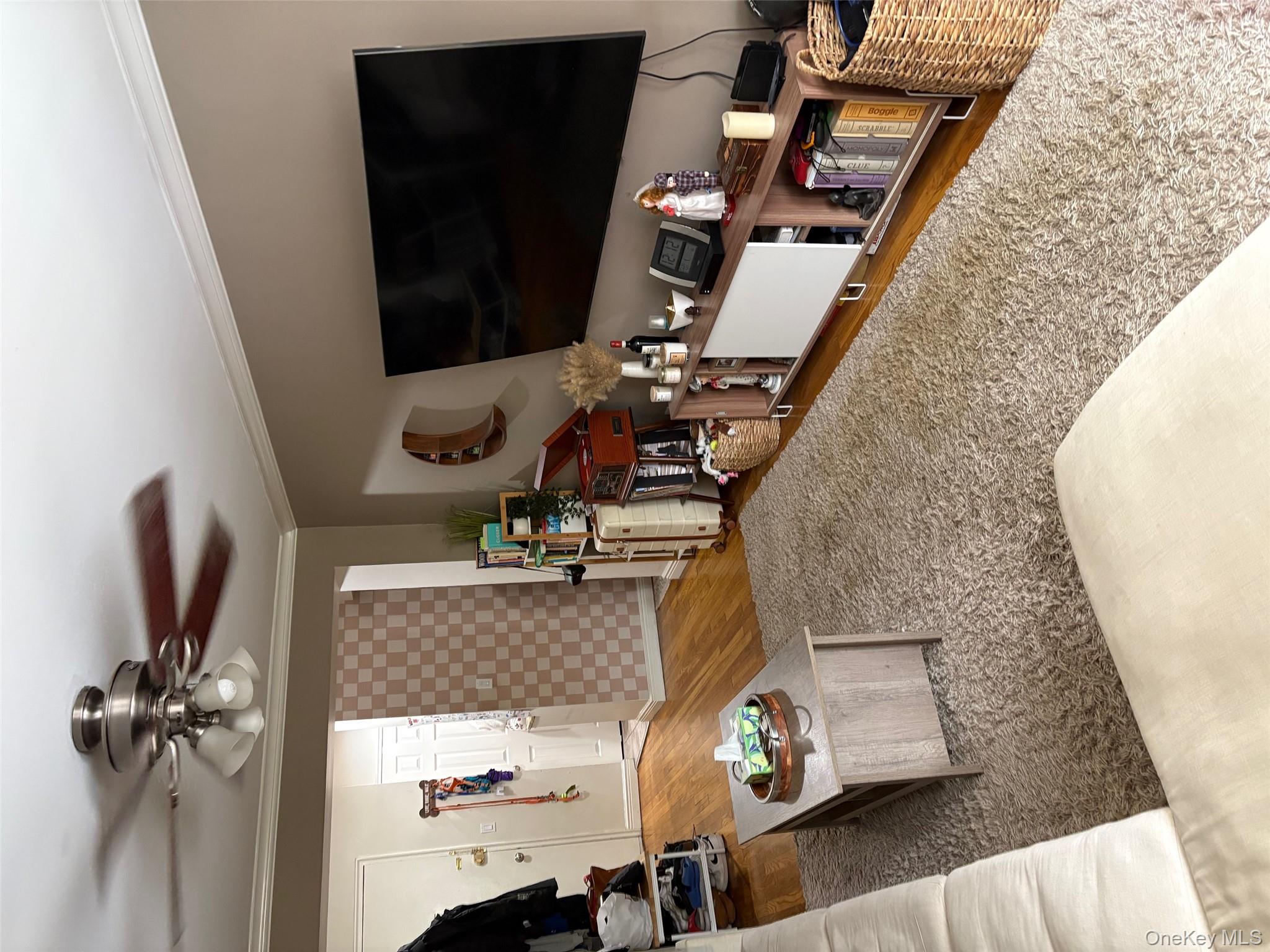 2295 Palmer Avenue, Unit 1N New Rochelle, NY 10801 - Photo 6 of 16 a living room with furniture and a flat screen tv