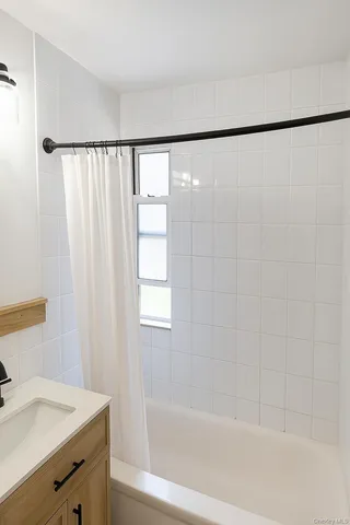 a bathroom with a shower curtain and a sink