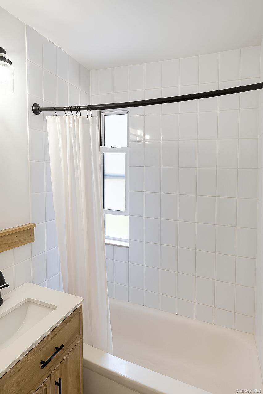 2295 Palmer Avenue, Unit 1N New Rochelle, NY 10801 - Photo 7 of 16 a bathroom with a shower curtain and a sink