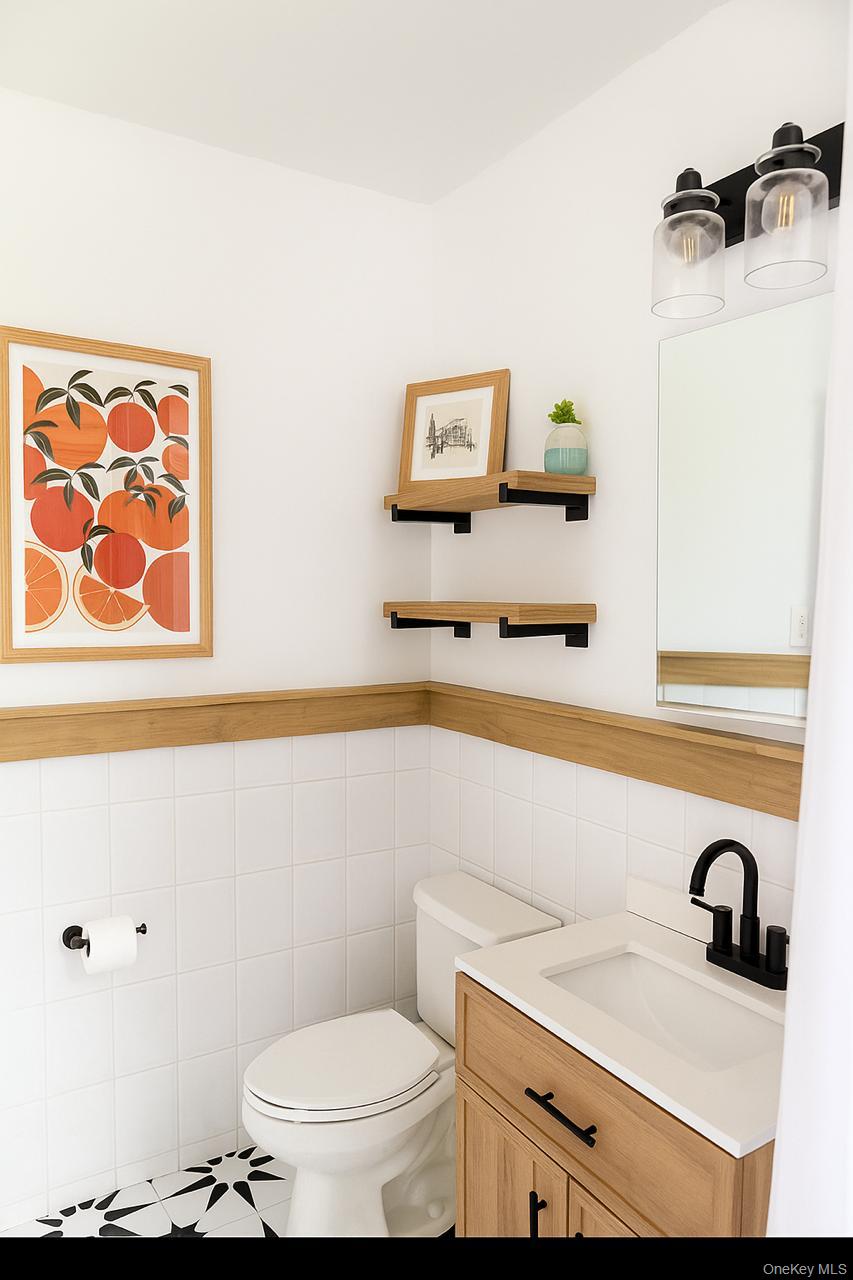 2295 Palmer Avenue, Unit 1N New Rochelle, NY 10801 - Photo 8 of 16 a bathroom with a sink a toilet and mirror