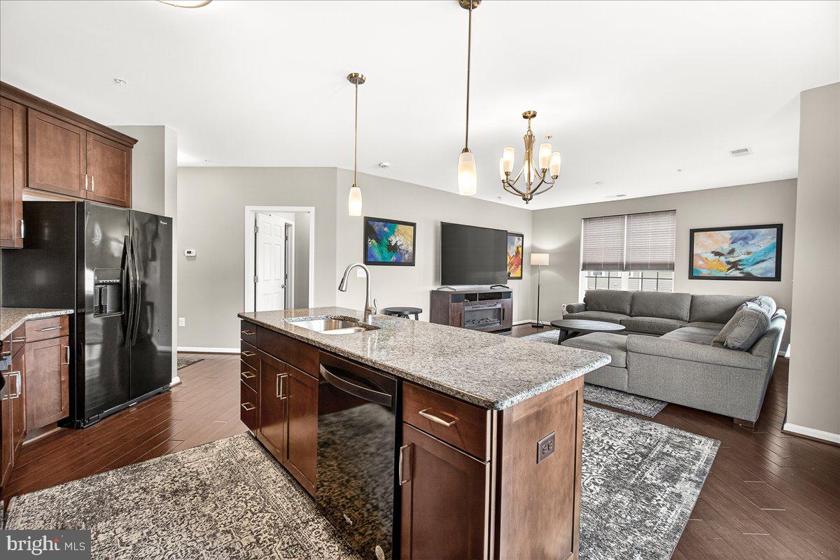 3911 Doc Berlin Drive, Unit 37 Silver Spring, MD 20906 - Photo 11 of 35 a living room with stainless steel appliances granite countertop furniture wooden floor and a view of kitchen