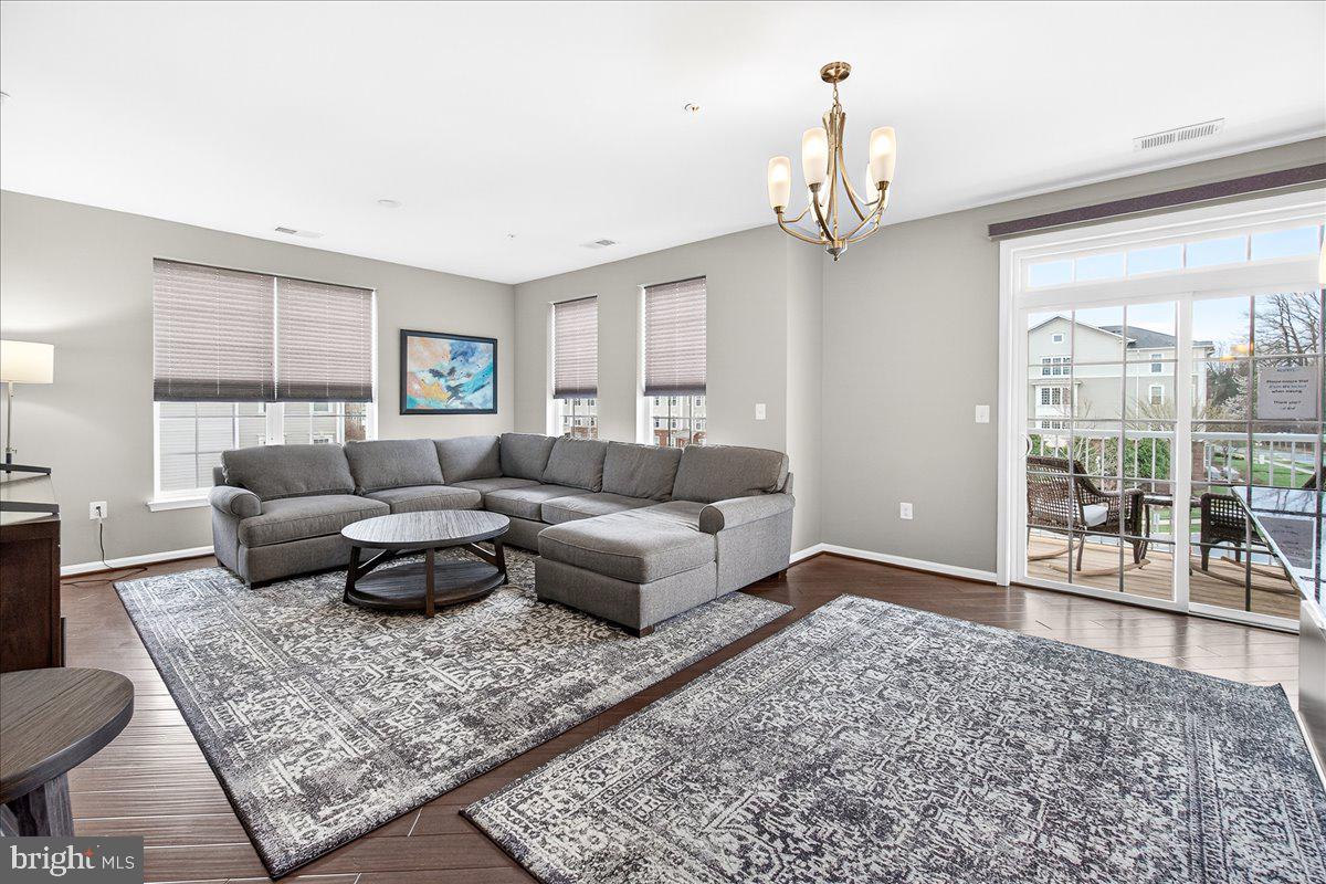 3911 Doc Berlin Drive, Unit 37 Silver Spring, MD 20906 - Photo 15 of 35 a living room with furniture and a chandelier