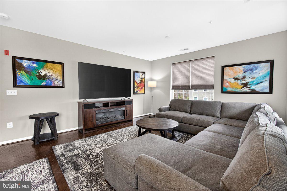 3911 Doc Berlin Drive, Unit 37 Silver Spring, MD 20906 - Photo 17 of 35 a living room with furniture and a flat screen tv