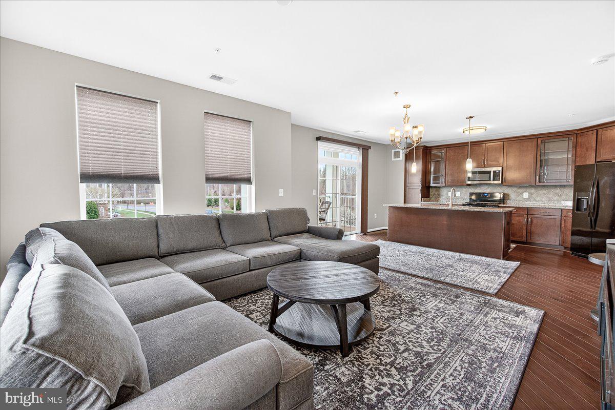 3911 Doc Berlin Drive, Unit 37 Silver Spring, MD 20906 - Photo 18 of 35 a living room with furniture and a kitchen view