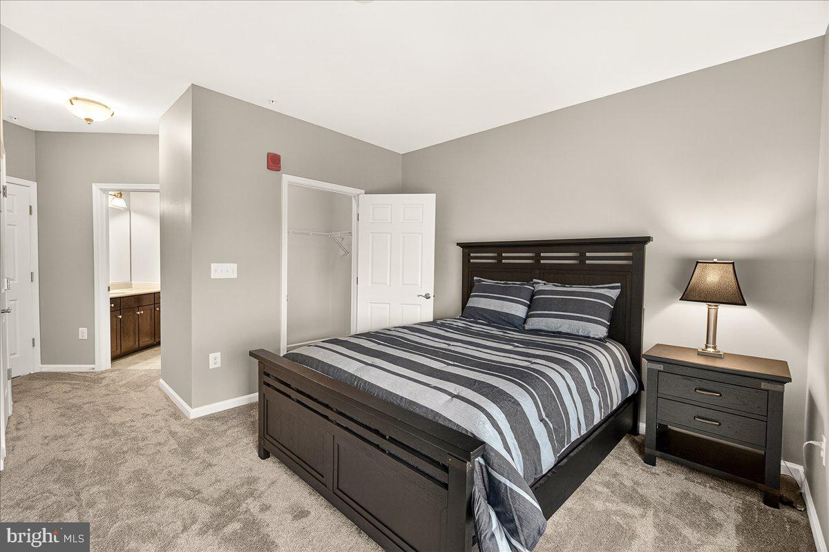 3911 Doc Berlin Drive, Unit 37 Silver Spring, MD 20906 - Photo 20 of 35 a bedroom with a bed and a lamp
