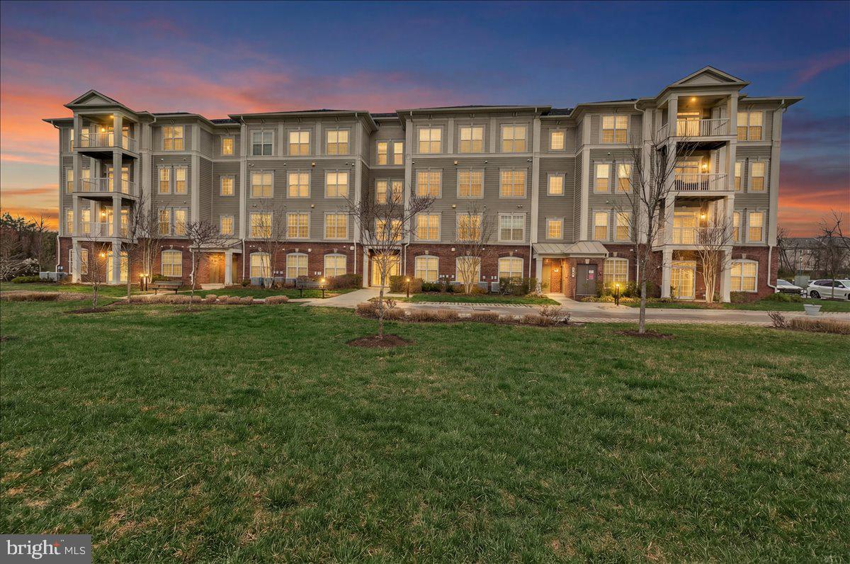3911 Doc Berlin Drive, Unit 37 Silver Spring, MD 20906 - Photo 2 of 35 a front view of building with yard and outdoor seating