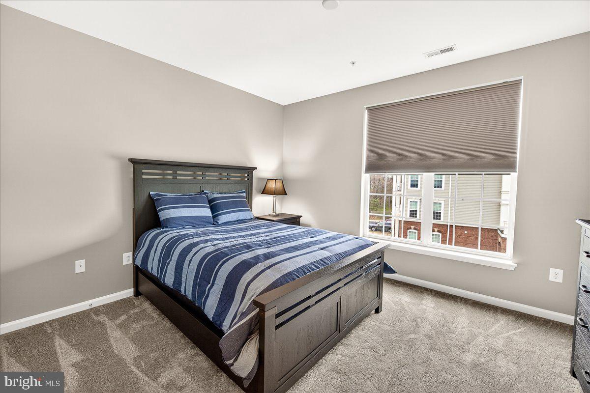 3911 Doc Berlin Drive, Unit 37 Silver Spring, MD 20906 - Photo 21 of 35 a bedroom with a bed and window
