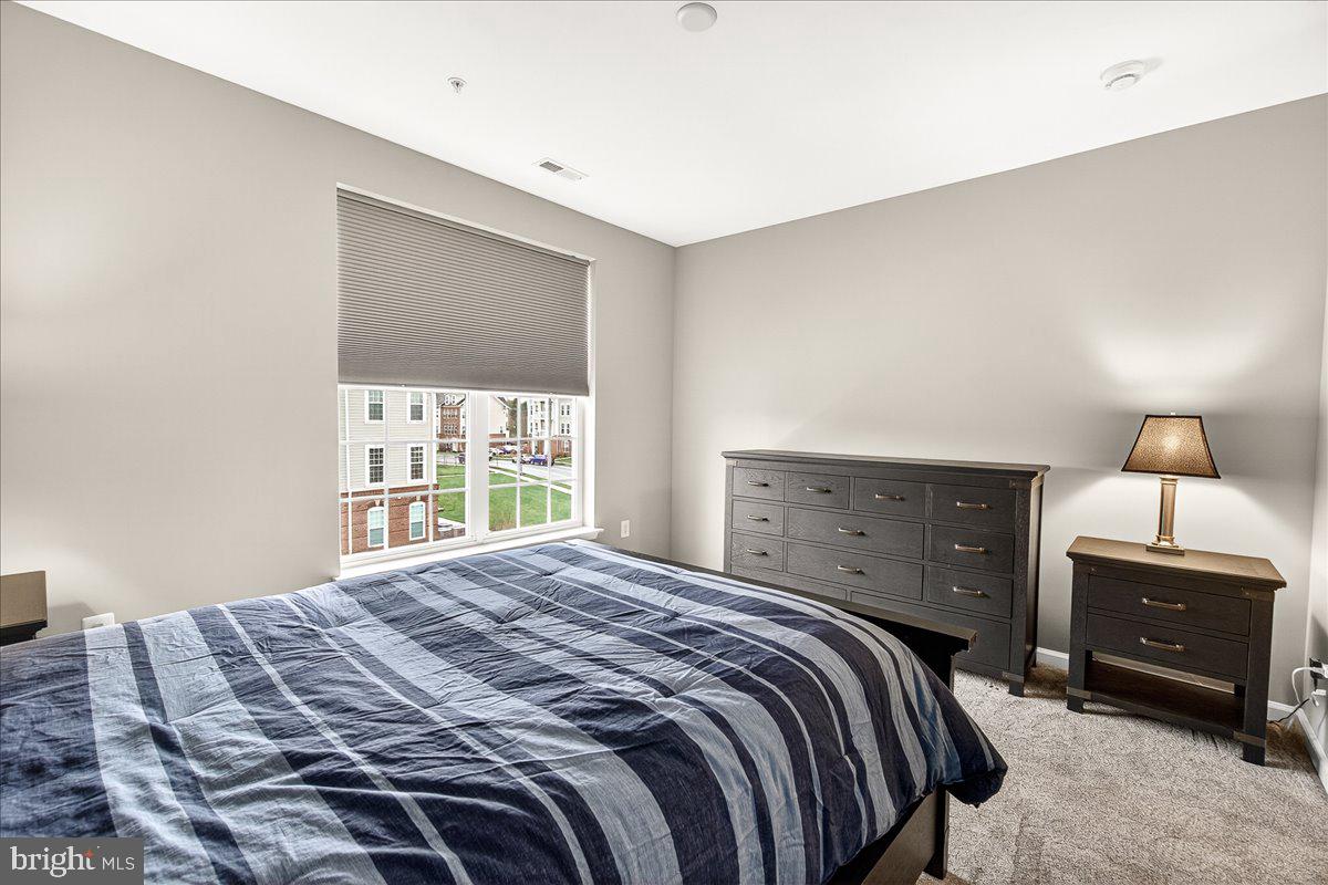 3911 Doc Berlin Drive, Unit 37 Silver Spring, MD 20906 - Photo 22 of 35 a bedroom with a bed and a window