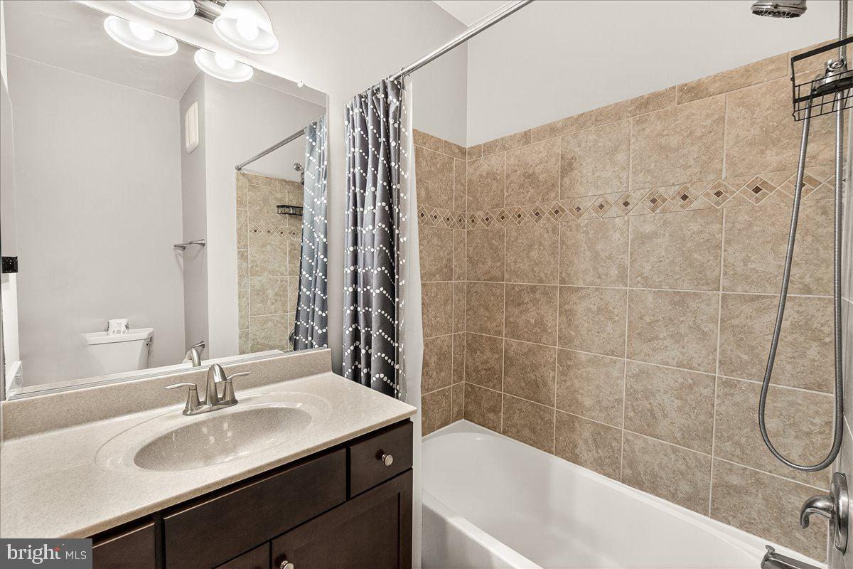 3911 Doc Berlin Drive, Unit 37 Silver Spring, MD 20906 - Photo 28 of 35 a bathroom with a sink and a mirror