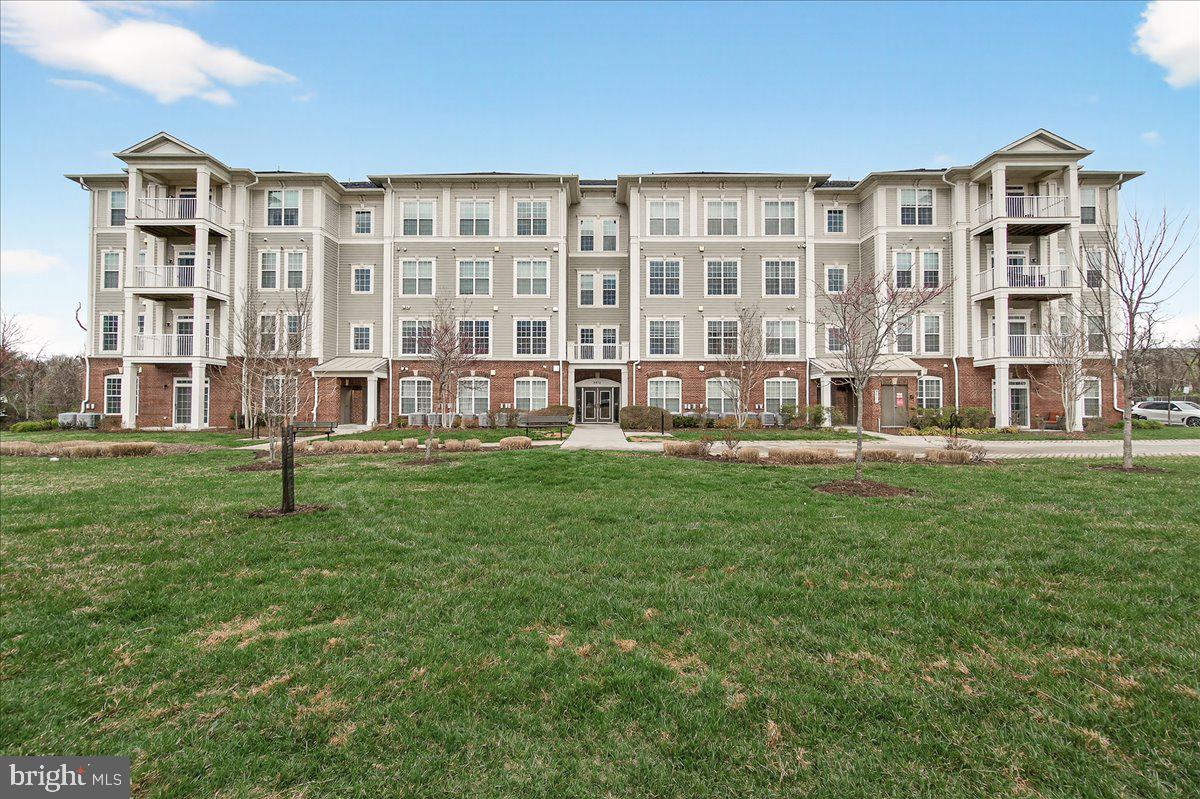 3911 Doc Berlin Drive, Unit 37 Silver Spring, MD 20906 - Photo 31 of 35 a front view of a building with a yard