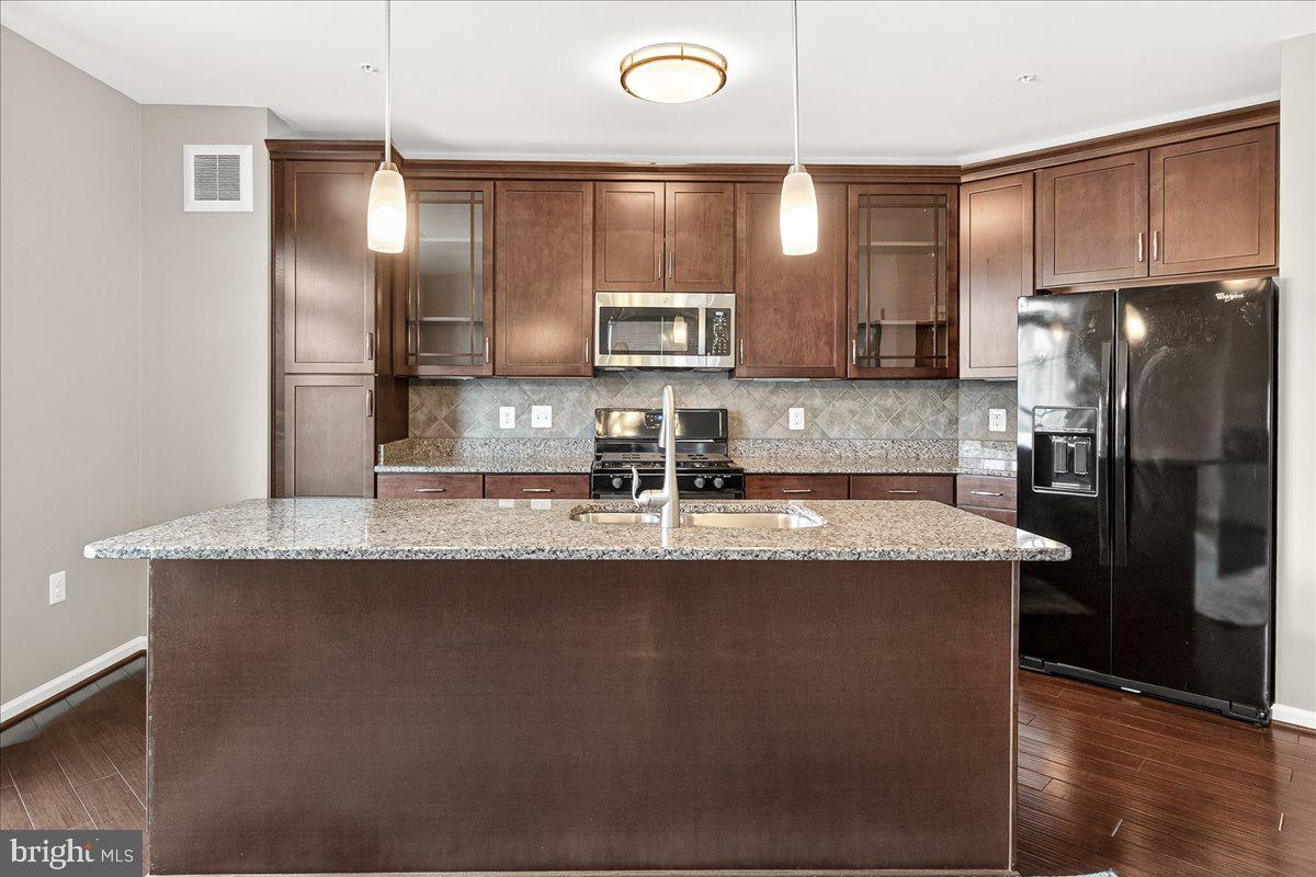 3911 Doc Berlin Drive, Unit 37 Silver Spring, MD 20906 - Photo 10 of 35 a kitchen with stainless steel appliances granite countertop a sink a refrigerator and a stove