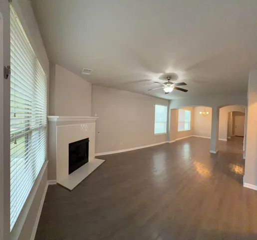 a view of empty room with fireplace and fan