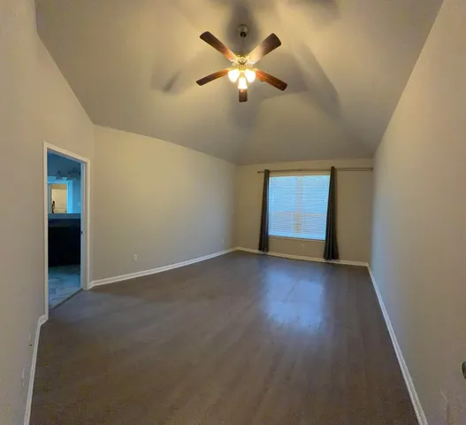 an empty room with closet and windows