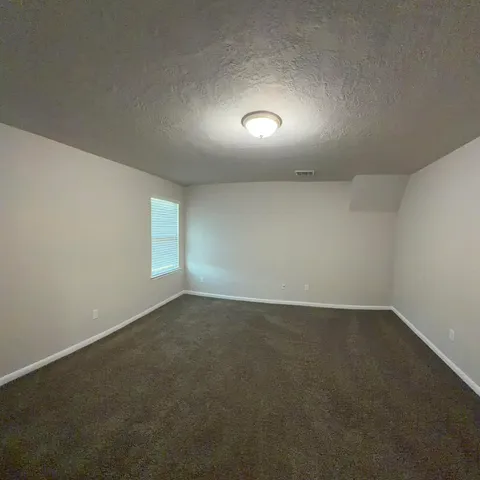 a bathroom with a granite countertop sink a large mirror and a toilet