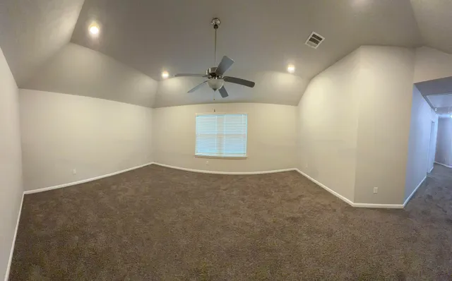 an empty room with a empty space and a ceiling fan