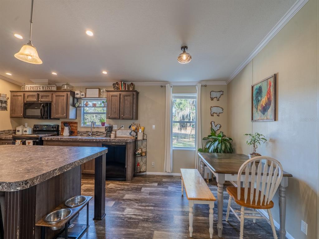 22457 Northeast 130th Court Road Fort McCoy, FL 32134 - Photo 12 of 43 a kitchen with a table and chairs in it